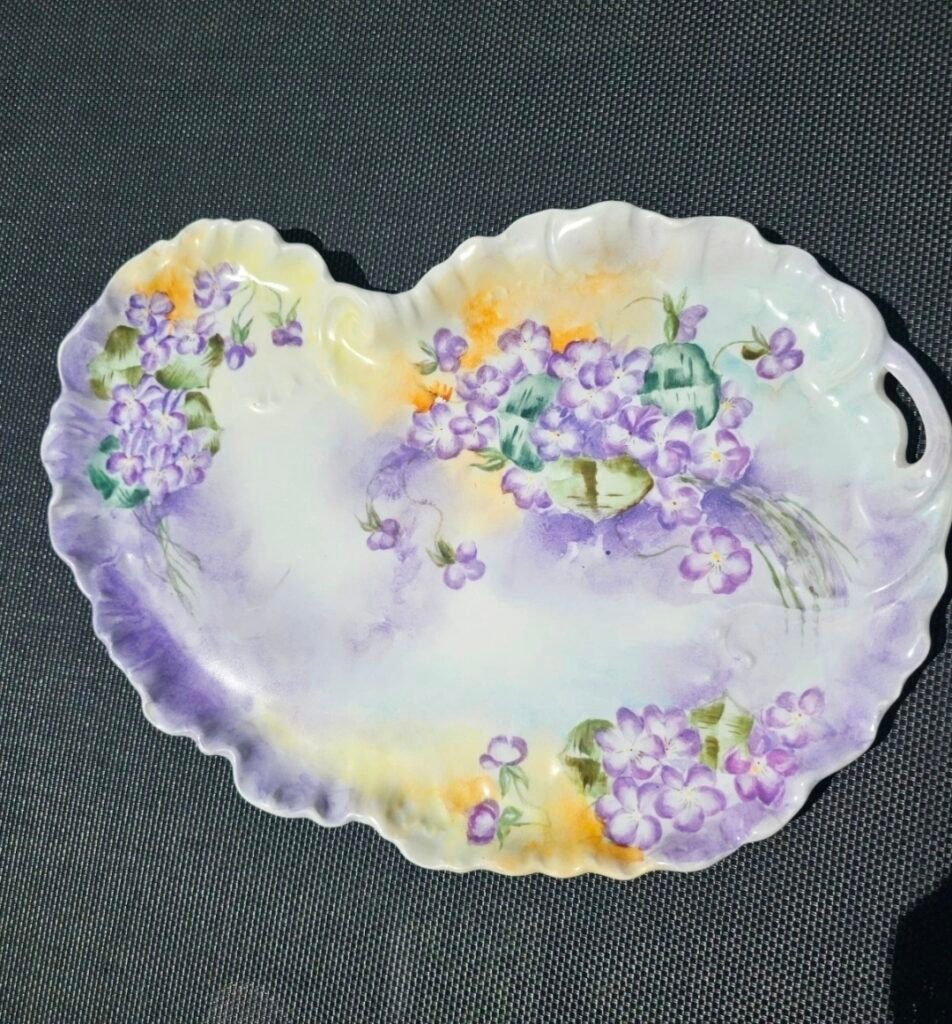 Hand-painted porcelain tray with purple violets on a pastel ground, with scrolled rim and pierced handle