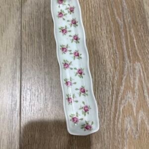 Long narrow porcelain tray scattered with small pink rosebuds