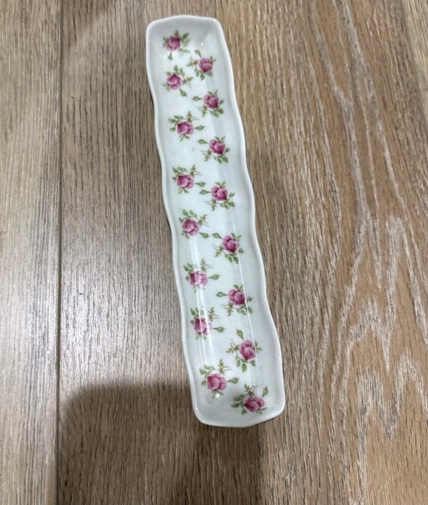 Long narrow porcelain tray scattered with small pink rosebuds