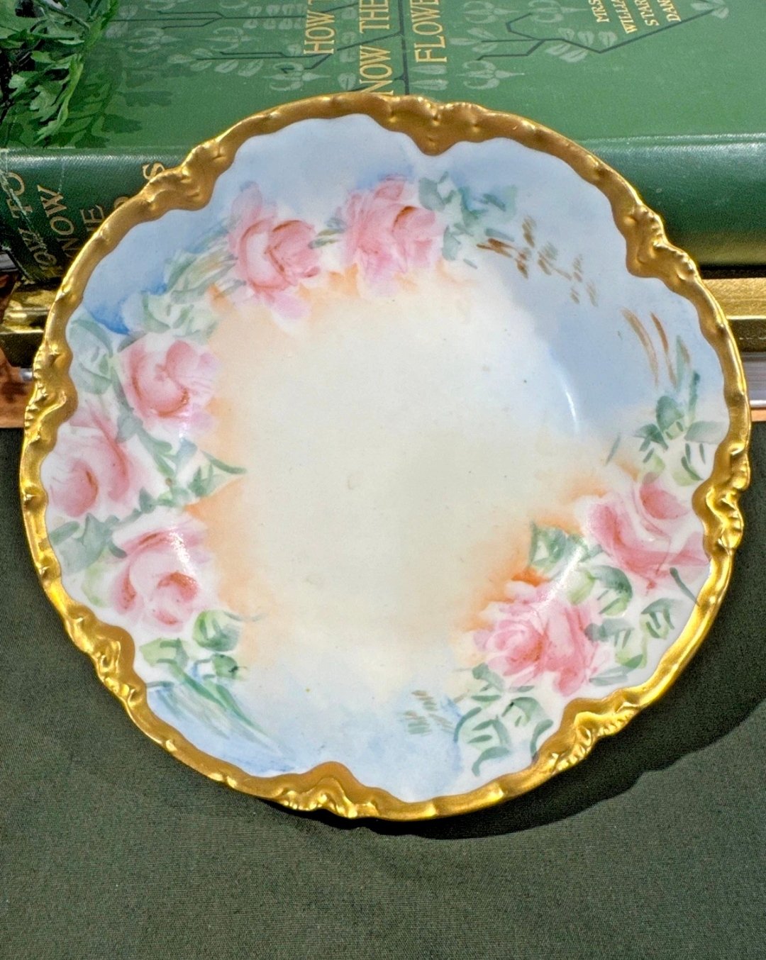 Hand-painted porcelain bowl with pink roses and a heavy rococo gold rim